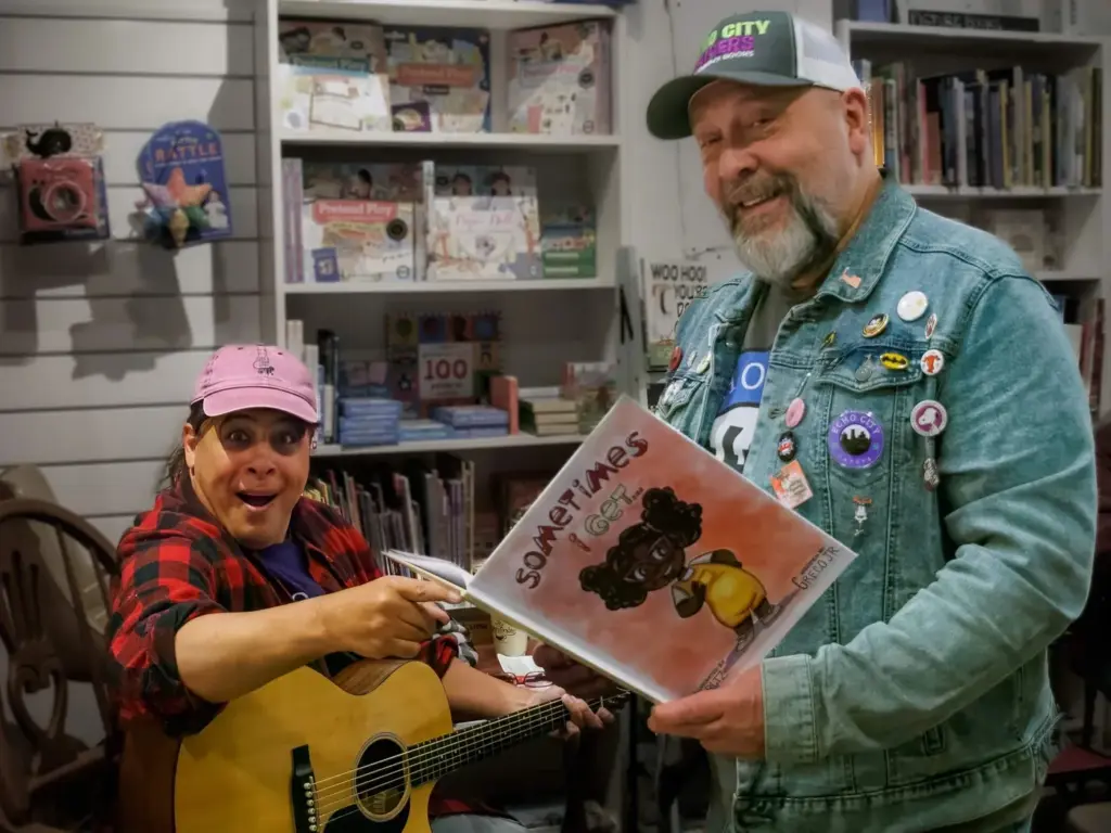 Joe (illustrator) and Ralph (author) of Echo City Capers reading to a young fan
